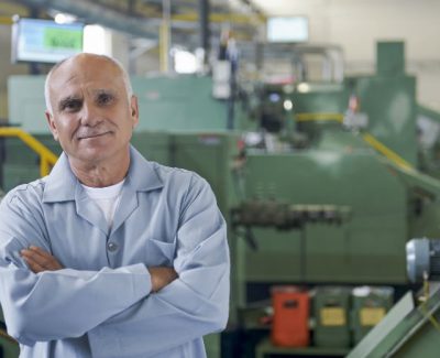 Old man working in a factory