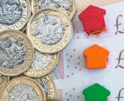 one pound coins on top of ten pound notes