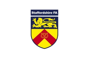 Staffordshire FA crest shield in blue, yellow, and red with a golden lion and a Staffordshire knot.